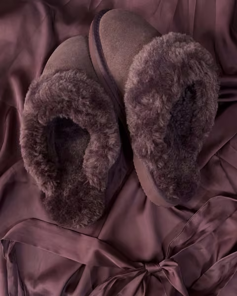 The Elysian in Blood Moon, deep burgundy shearling slippers on wine satin