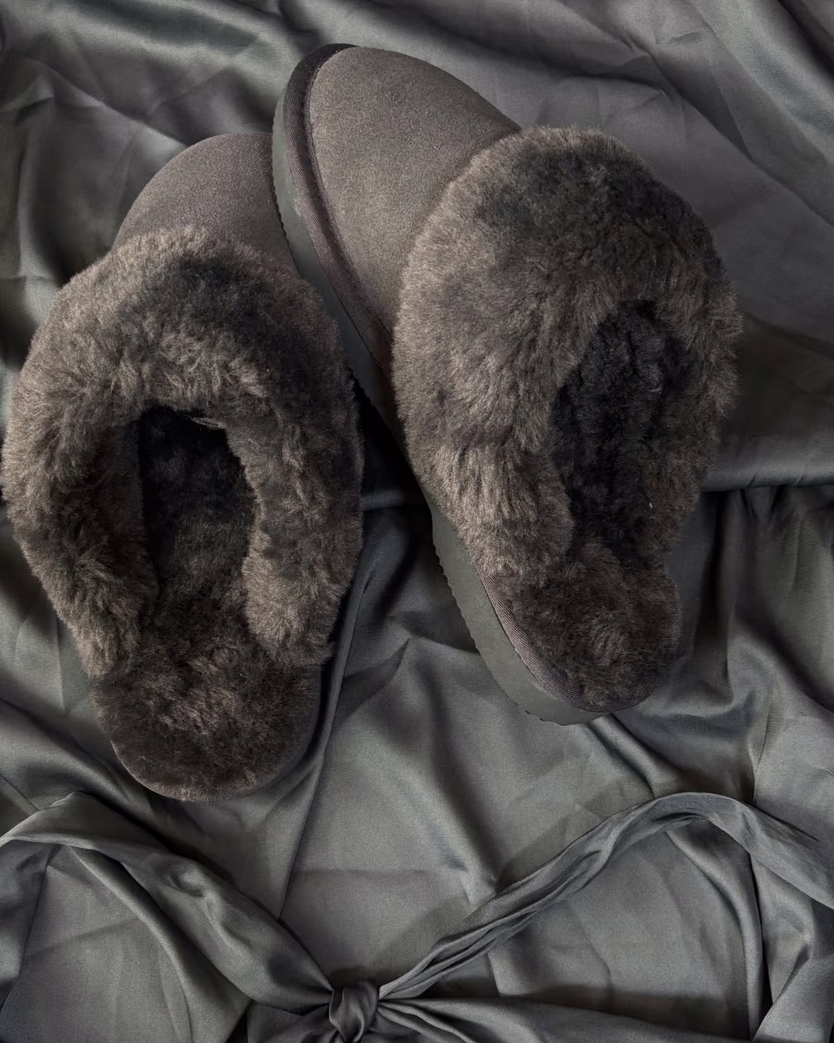 The Elysian in Cruel Sea, deep grey-green shearling slippers on sage satin