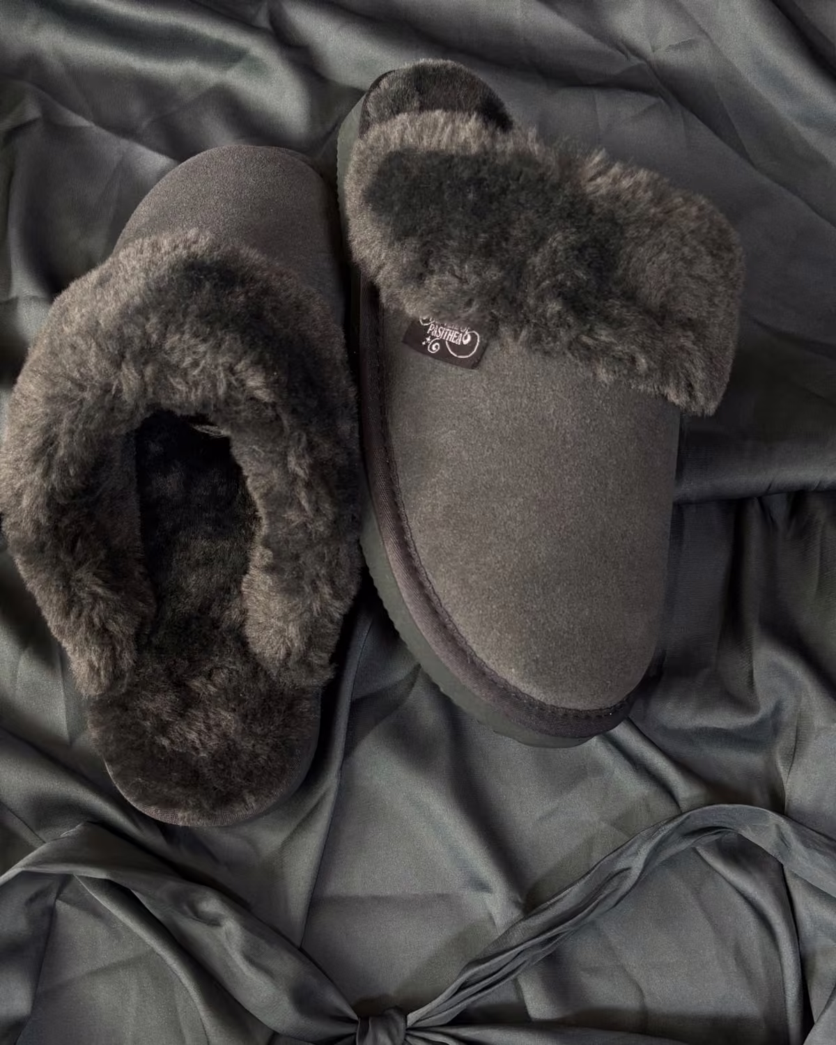 The Elysian in Cruel Sea, deep grey-green shearling slippers on sage satin