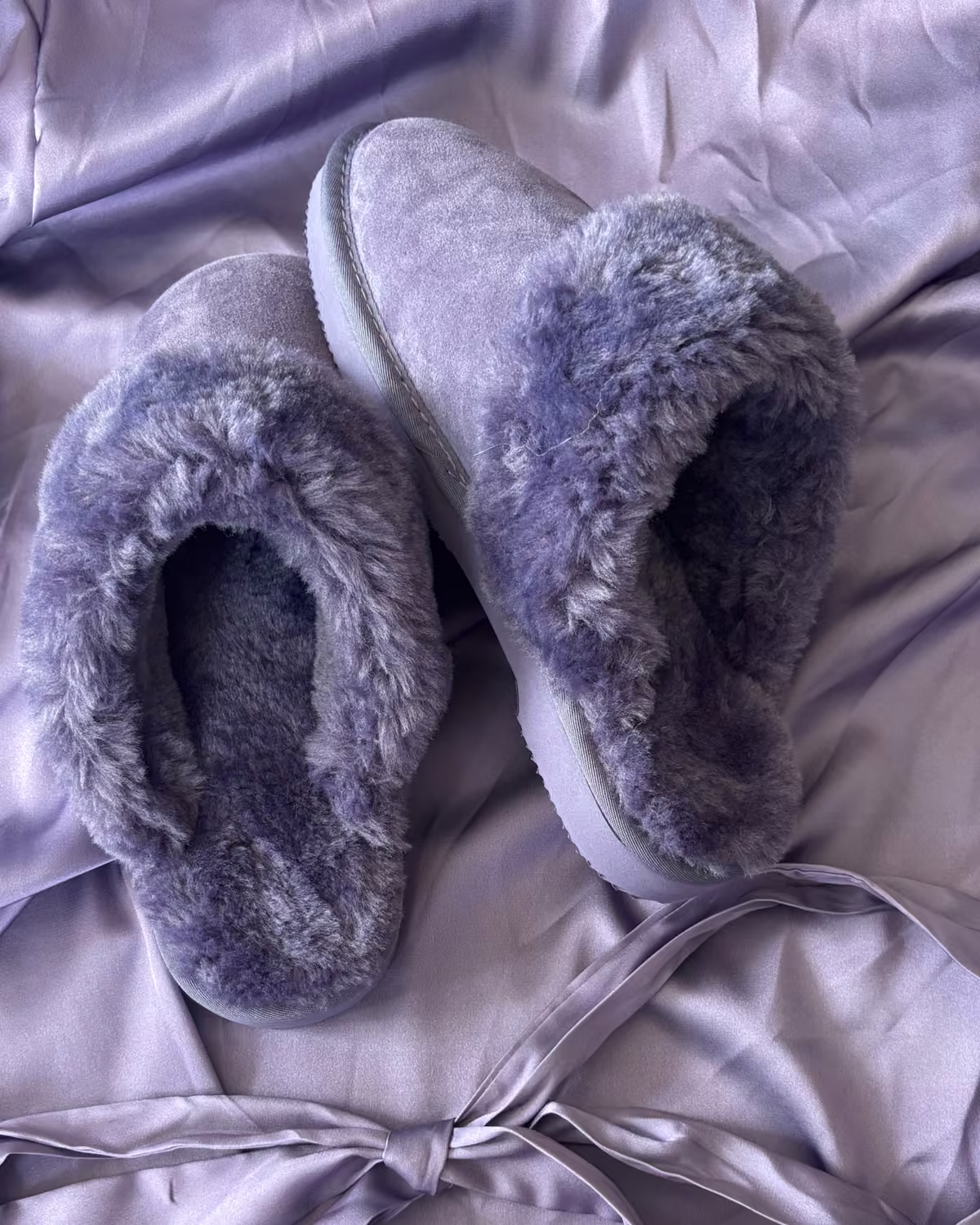 The Elysian in Lavender Fog, soft violet shearling slippers on lavender satin